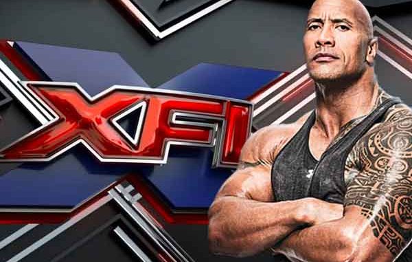 the Rock posing in front of XFL logo