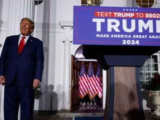 Donald Trump standing next to a 2024 campaign podium