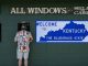 a man placing a bet at a sportsbook window next to a Welcome to Kentucky sign