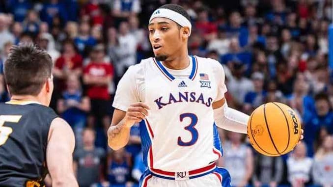 Dajuan Harris of the Kansas Jayhawks basketball team taking the ball upcourt