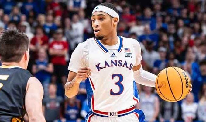 Dajuan Harris of the Kansas Jayhawks basketball team taking the ball upcourt