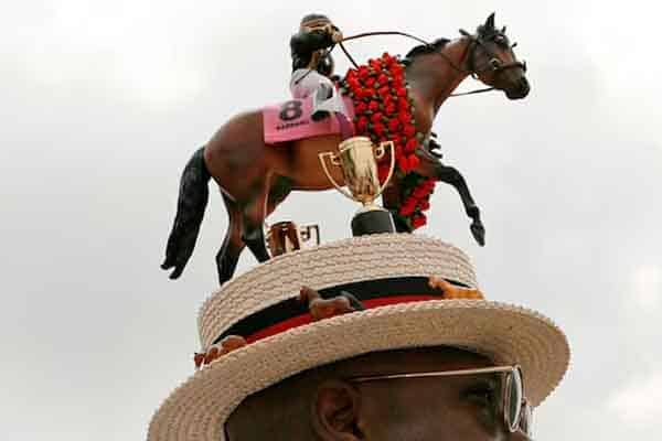 a Kentucky Derby hat with a racehorse on top of it