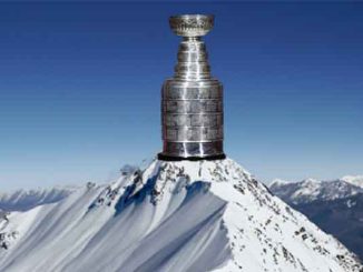 the NHL Stanley Cup sitting on top of a snowy mountain peak