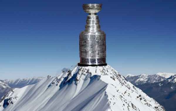 the NHL Stanley Cup sitting on top of a snowy mountain peak