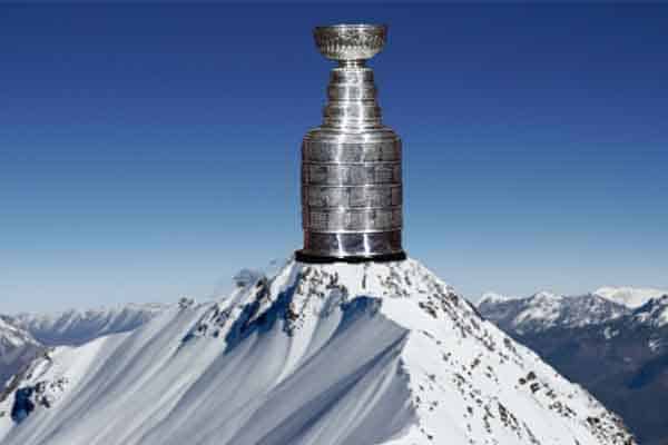 the NHL Stanley Cup sitting on top of a snowy mountain peak