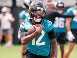 Travis Hunter running with the football during practice with the Jacksonville Jaguars
